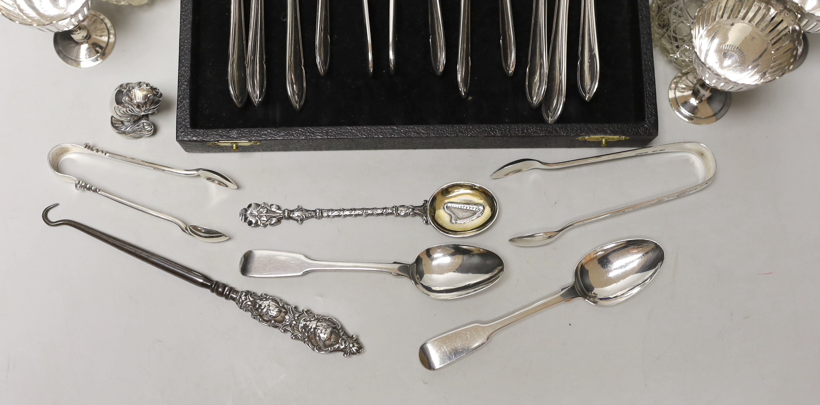 Sundry small silverwares including flatware, a pair of mounted glass scent bottles, a white metal German dish and minor plated items.
